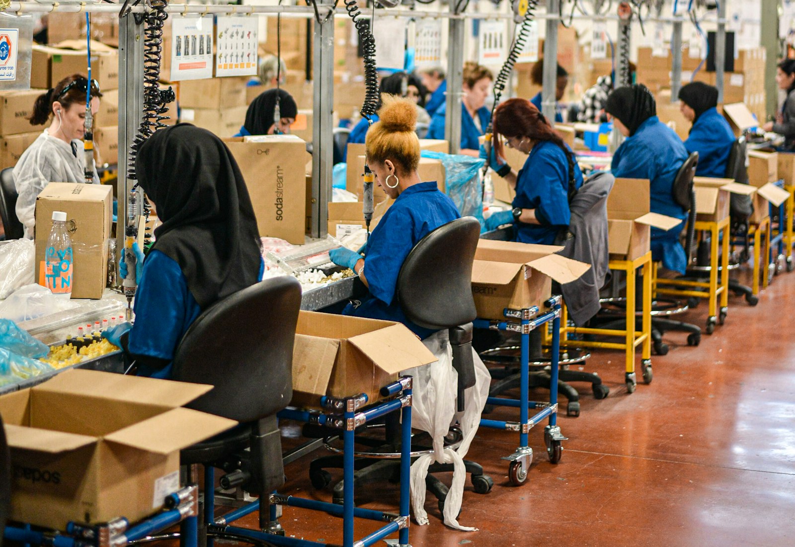A shift worker using a handheld terminal on a factory floor